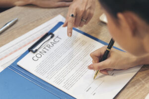 Close up Team Businesswoman hands partners sign contract with success business deal.