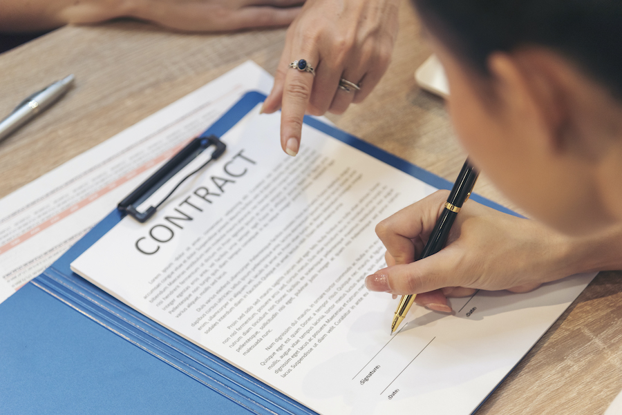 Close up Team Businesswoman hands partners sign contract with success business deal.